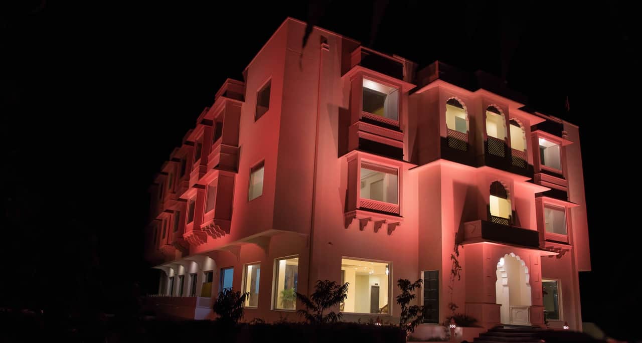 Facade of WelcomHeritage Mount Valley Resort at night