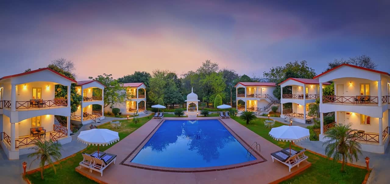 Swimming pool and cottages at Tiger Den Resort