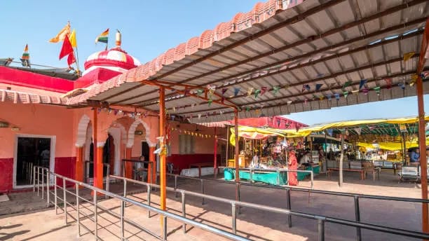 Red Trinetra Ganesh Temple with pilgrims inside Ranthambore Fort